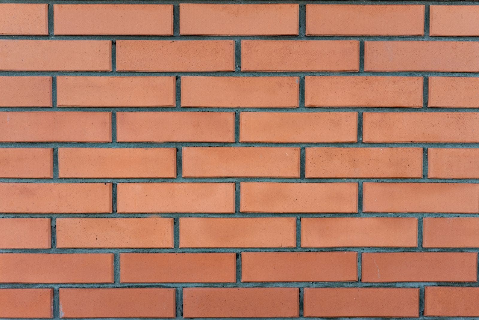 Clean red brick wall with even mortar lines